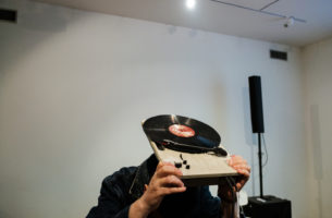 A User's Guide to Authenticity is a Feeling performance man holding record player