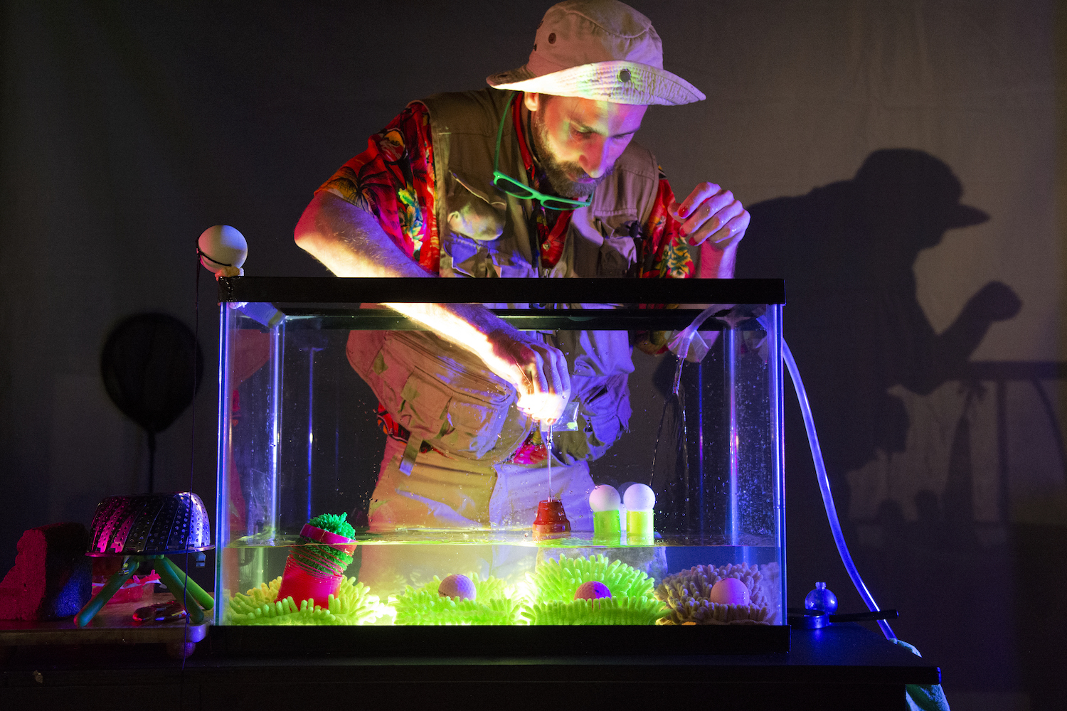 High Water performance man reaching into glass tank