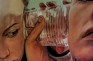 Two people listening via a cup