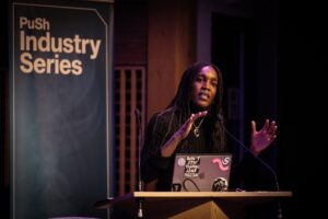 Woman giving speech on stage at Push Industry Series